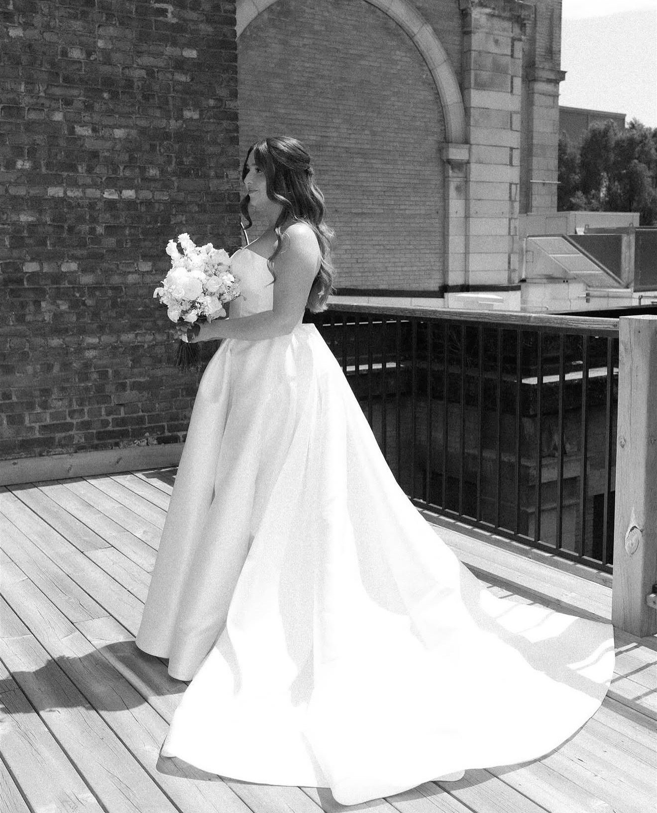 Bride with cascading waves on a rooftop, black and white