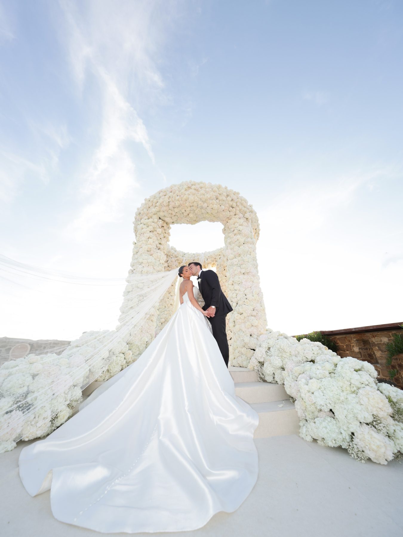 Bride on balcony overlooking the coast at sunset, Cilento, Italy