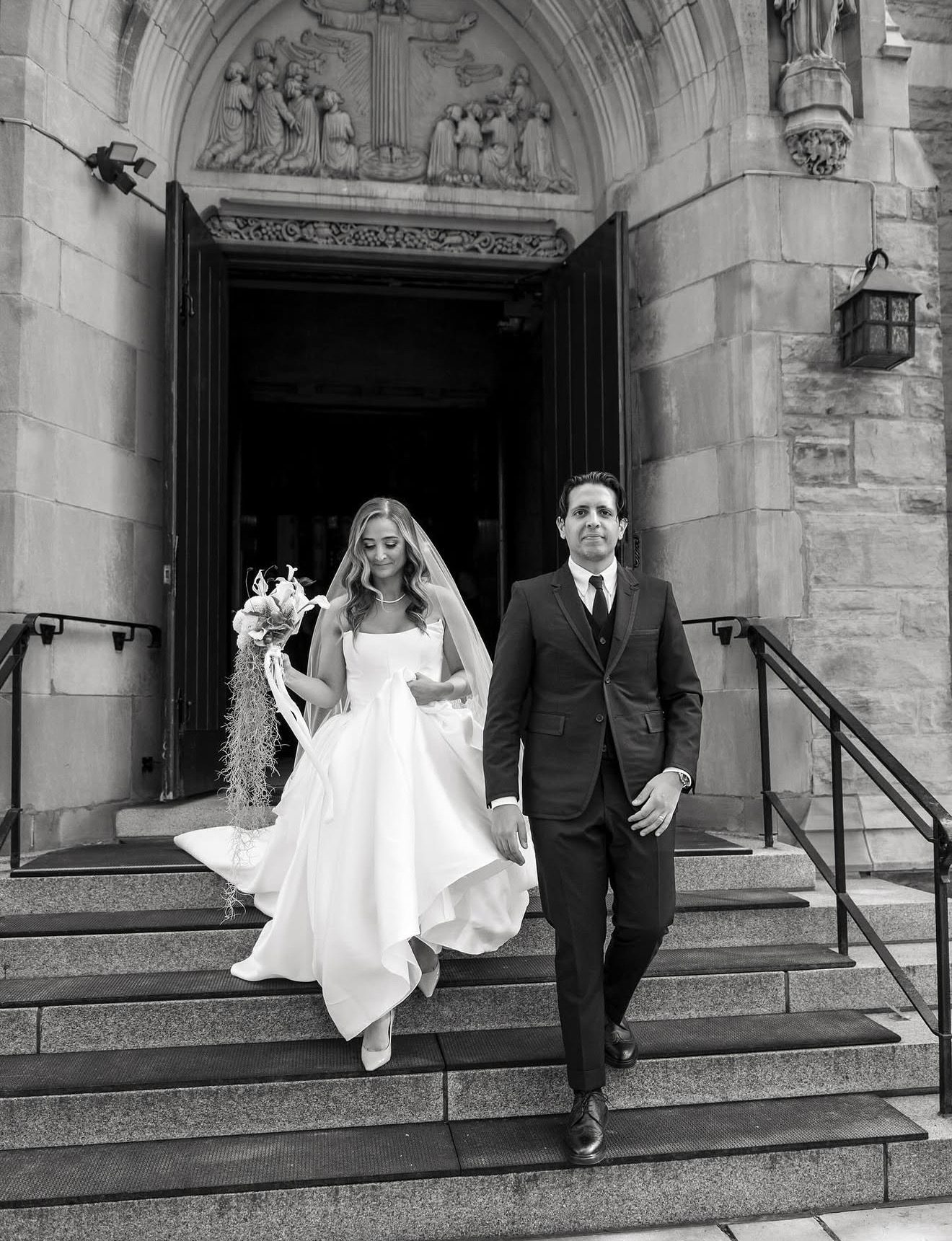 Bride and groom leaving a church, black and white