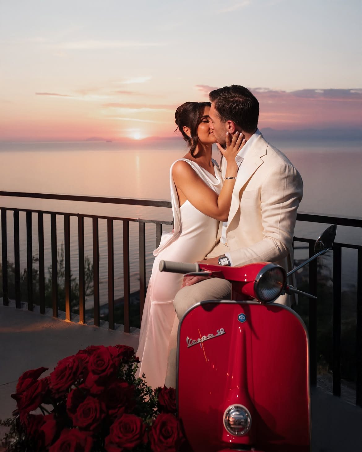 Bride and groom kissing on a vintage Vespa at sunset, Italy