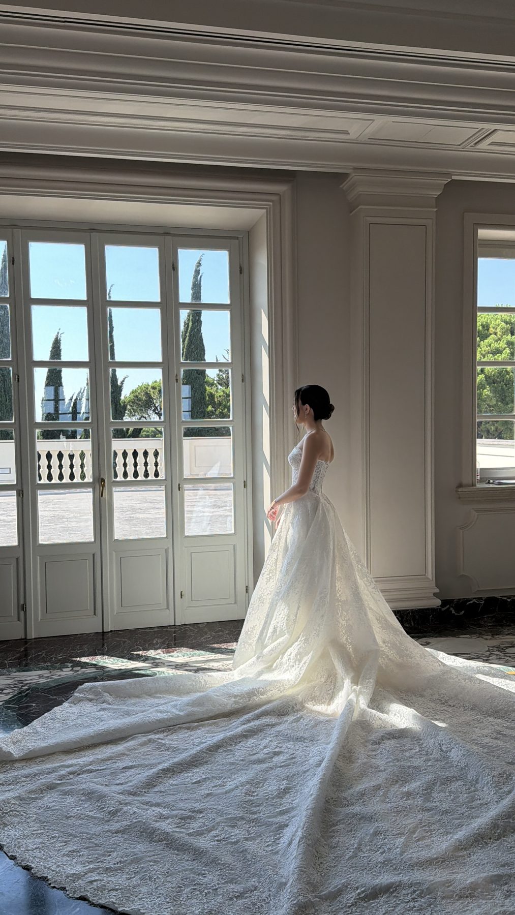 Bride standing by a window in a villa, Italy