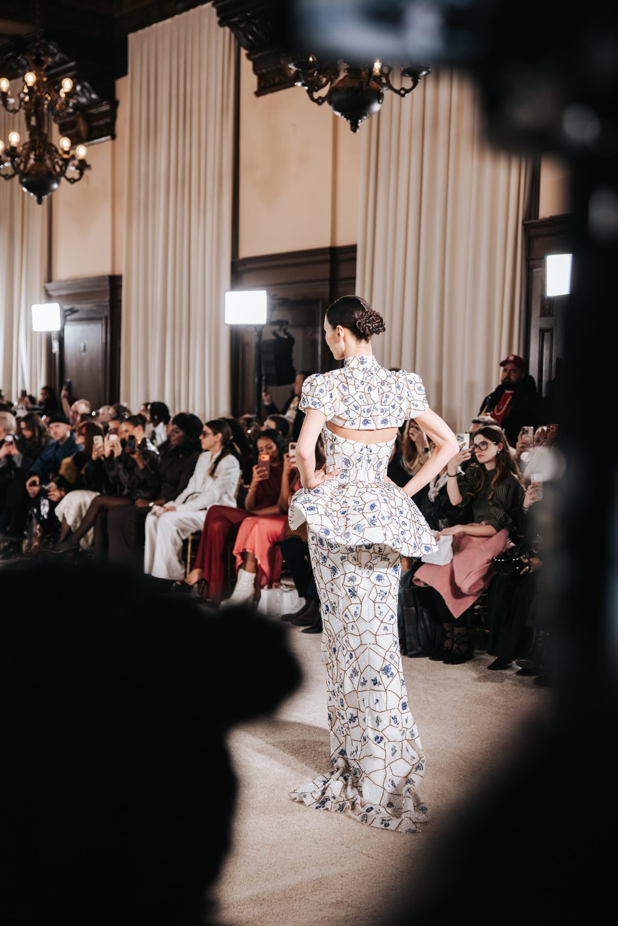 Runway model from behind showing braided low bun, Nardos NYFW show