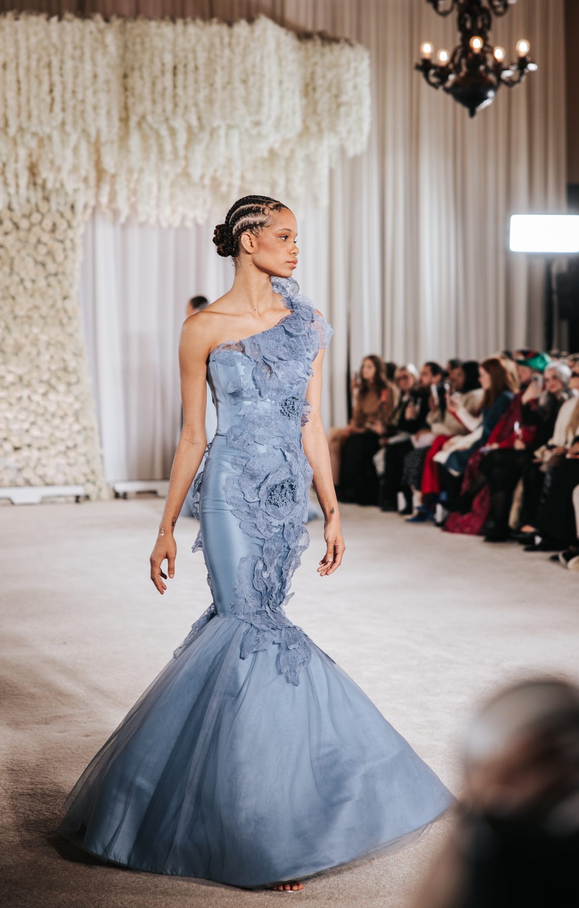 Runway model with cornrow braids styled into a low bun, Nardos NYFW show