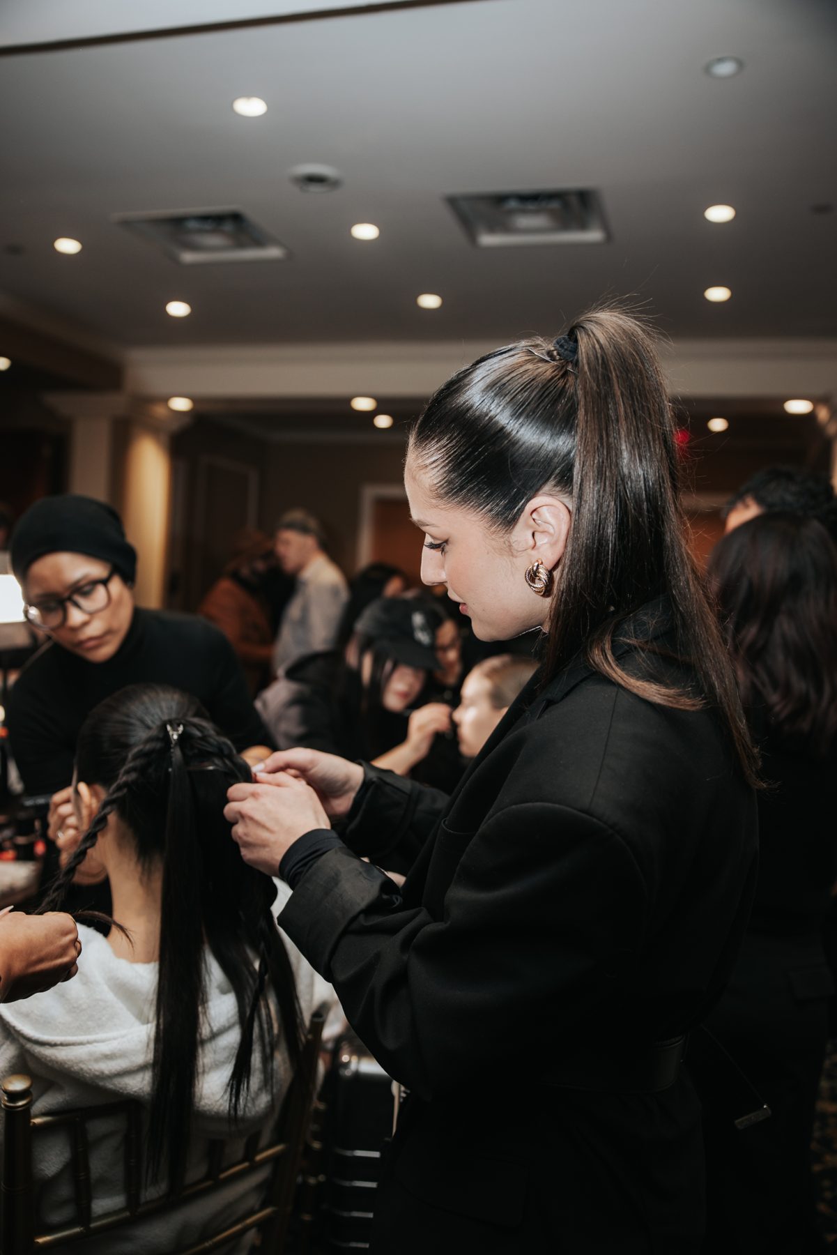 Ivana backstage styling a model's hair before the Nardos NYFW show