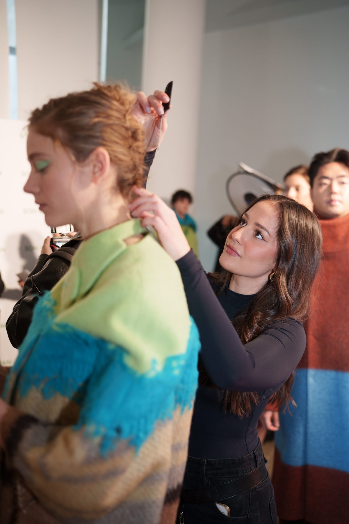 Ivana finishing a model's braid backstage at the Son Jung Wan NYFW show