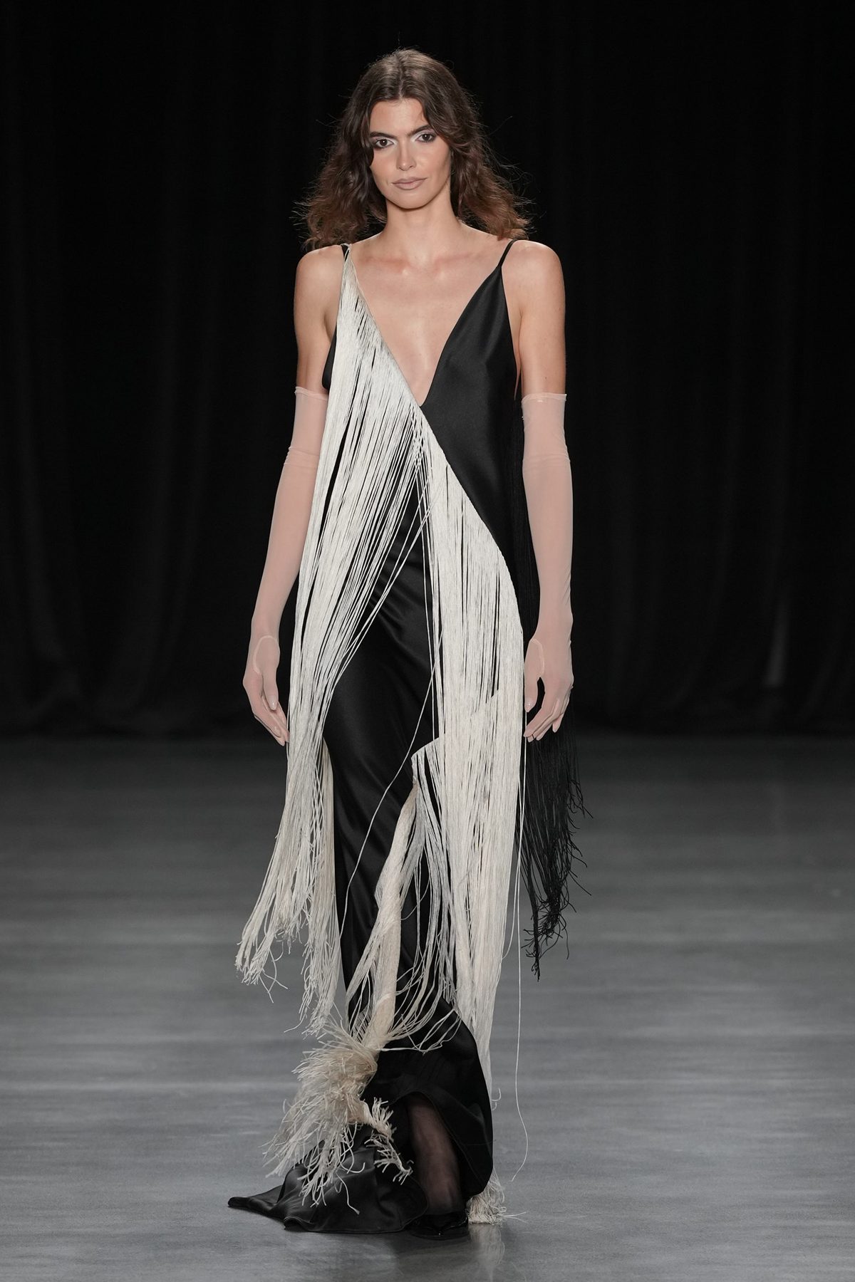 Runway model with natural waves in black fringe gown, Christian Cowan Spring 2027 show