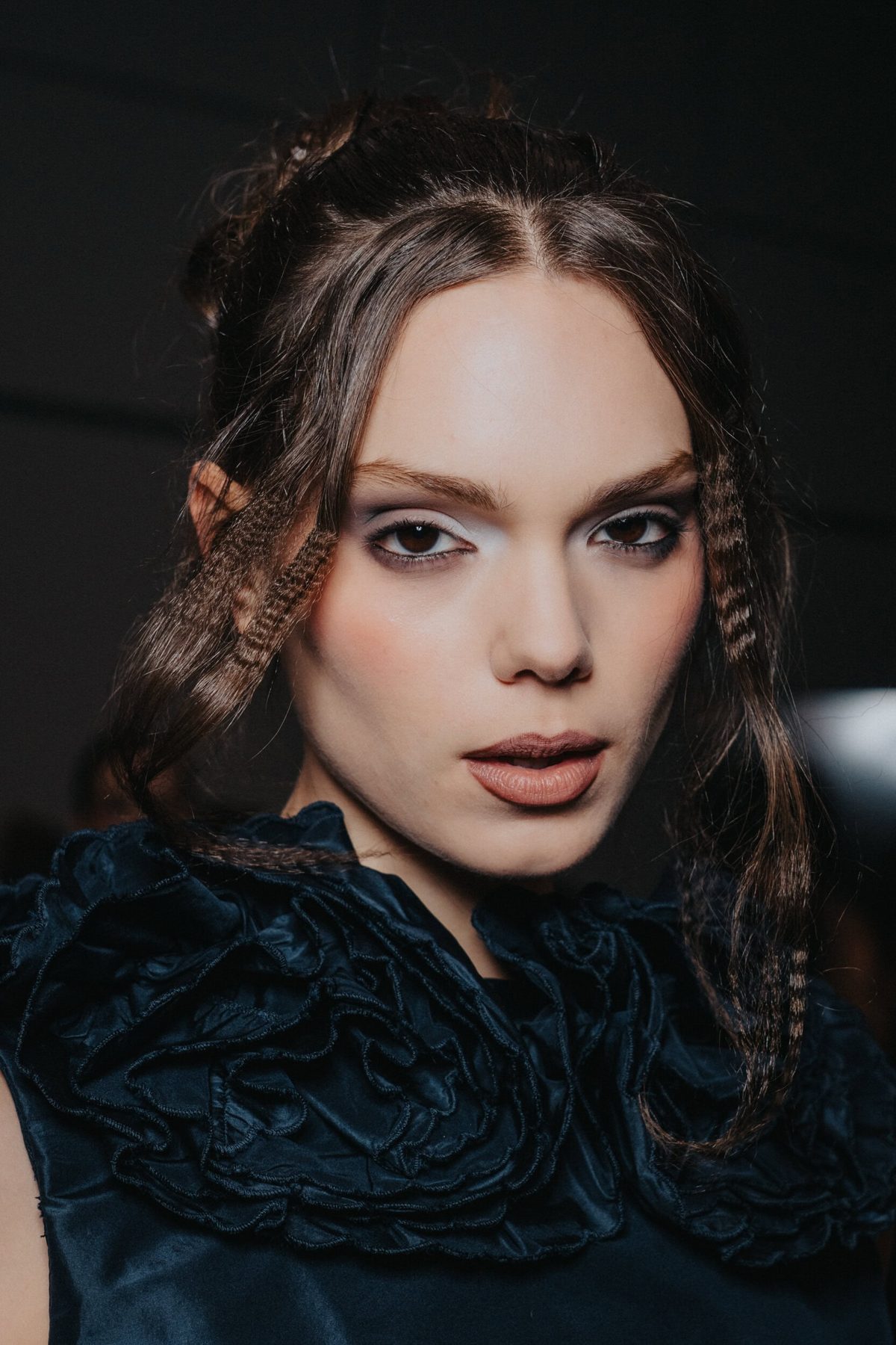 Close-up beauty detail of crimped face-framing pieces, Christian Cowan Spring 2027 backstage